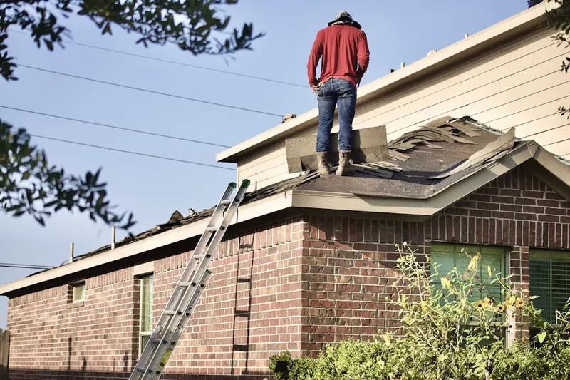Professional roofer working on a residential roof in Yelm